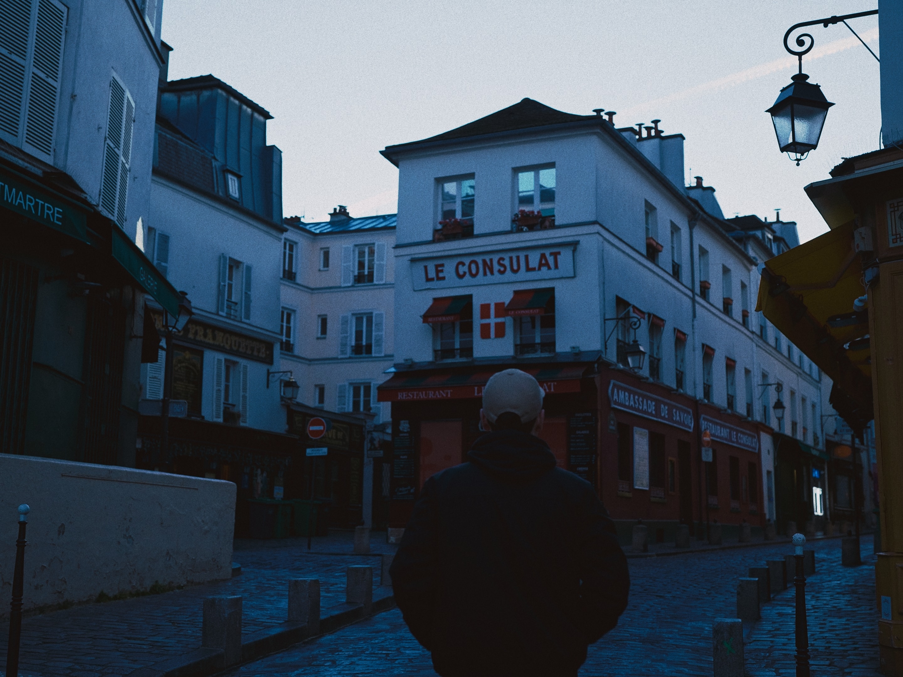 Evening falls over Montmartre, a lone figure heading home.